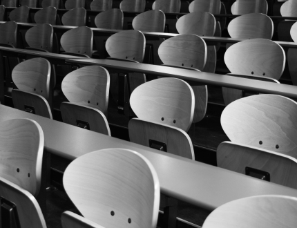 Rows of tables and chairs in a lecture hall