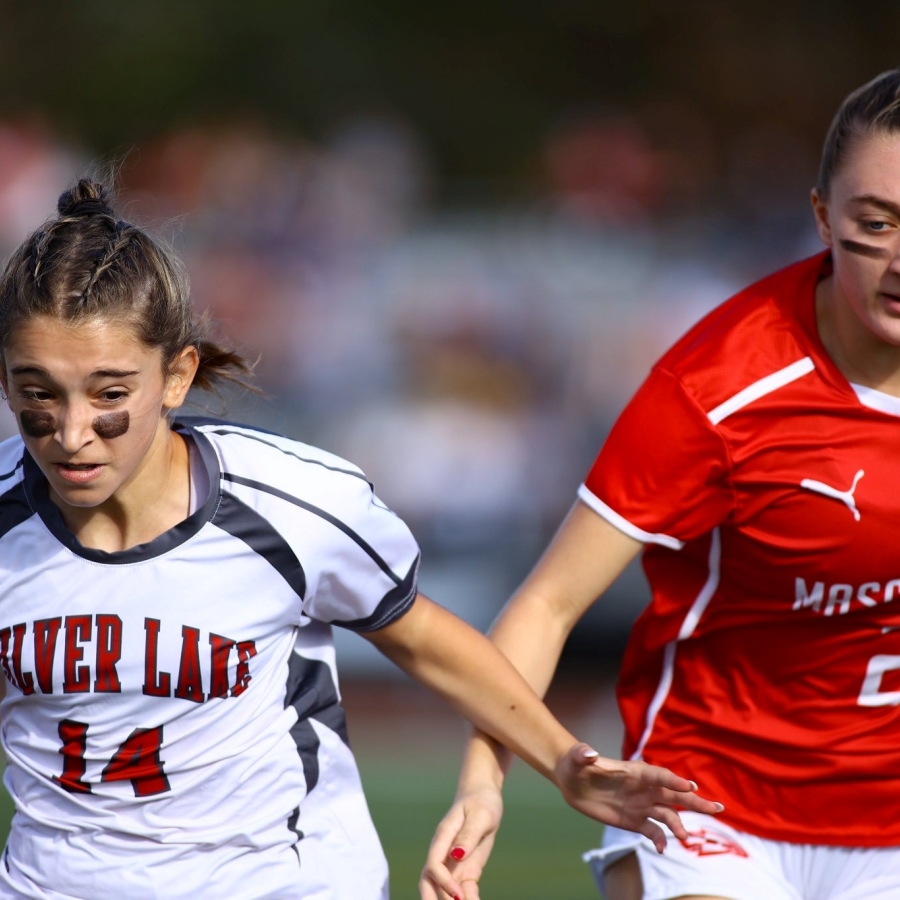 Two soccer players from opposing teams