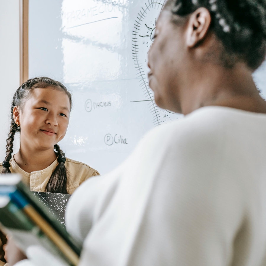A teacher talks to a student after class.